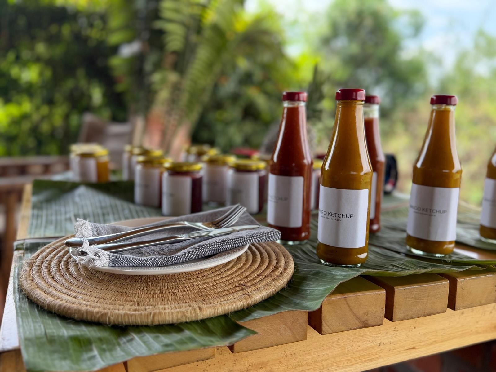 Bottles of locally produced mango ketchup on a wooden table